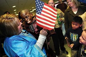 Karen holds her son Moses includes the American Flag