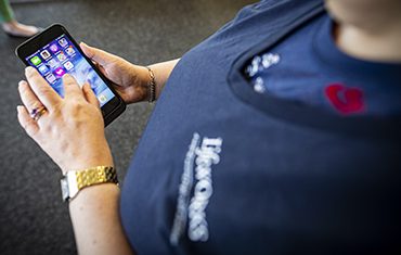 Woman looking at phone to request a ride