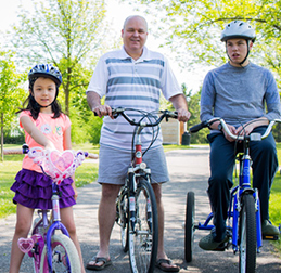 Louis McManus on his bike next to his father and sister.