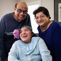 Father, mother, and daughter smiling. Lifeworks Personal Support and Respite.