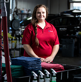 Women standing in her place of employment, a carwash