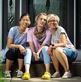 CDCS - FMS family served - Lifeworks - 3 people sitting on a front porch